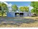 Exterior shot of a well-maintained barn with multiple stalls, perfect for agricultural pursuits or hobby farming at 23519 State Road 44, Eustis, FL 32736