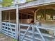 Internal view of barn featuring traditional wood beam architecture and built in stables at 23519 State Road 44, Eustis, FL 32736