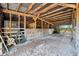 Well-lit barn interior featuring sturdy stalls with wooden gates, suitable for livestock or storage at 23519 State Road 44, Eustis, FL 32736