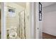 Small bathroom with a white toilet and a black and white shower curtain at 23519 State Road 44, Eustis, FL 32736