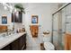 Bathroom features a modern vanity, updated lighting, and a glass-enclosed shower at 23519 State Road 44, Eustis, FL 32736