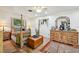Well-lit bedroom with wooden floors showcasing a four-poster bed and a dresser at 23519 State Road 44, Eustis, FL 32736