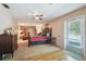Bedroom with a door to outside and a view of the living room at 23519 State Road 44, Eustis, FL 32736