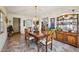 Formal dining room with glass-topped table, buffet, and view of kitchen at 23519 State Road 44, Eustis, FL 32736