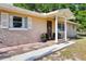 Inviting front porch with a charming entrance, decorative columns, and lush potted plants at 23519 State Road 44, Eustis, FL 32736