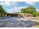 Charming single-story home with a large driveway, covered parking, and a well-maintained lawn at 23519 State Road 44, Eustis, FL 32736