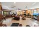 Spacious living room features a brick fireplace, wood paneled walls, and large windows at 23519 State Road 44, Eustis, FL 32736
