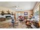 Cozy living room featuring a brick fireplace, ceiling fan, and comfortable seating at 23519 State Road 44, Eustis, FL 32736