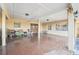 Covered outdoor area with an stained concrete floor, wooden doors, and windows, perfect for outdoor entertaining at 23519 State Road 44, Eustis, FL 32736