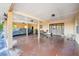 Covered outdoor parking area with an stained concrete floor, wooden doors, and windows at 23519 State Road 44, Eustis, FL 32736