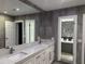 The spacious bathroom offers a double sink vanity and view to a soaking tub at 2600 Pisces Dr, Orlando, FL 32837