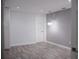 Bedroom with wood flooring, modern lighting fixture, neutral color scheme, and door at 2600 Pisces Dr, Orlando, FL 32837
