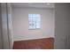 Sunlit room with wood-look flooring and a window with white blinds at 2600 Pisces Dr, Orlando, FL 32837