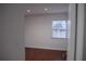 Bright, sunlit room with wood-look flooring, window, and neutral paint at 2600 Pisces Dr, Orlando, FL 32837
