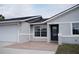 Charming single-story home featuring an attached garage, well-kept lawn and inviting entryway at 2600 Pisces Dr, Orlando, FL 32837