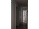 Bright hallway featuring tile floors and white trim leading to a bathroom with a white vanity at 2600 Pisces Dr, Orlando, FL 32837
