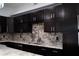 Updated kitchen with granite countertops, stainless steel sink and fixtures, and dark cabinetry at 2600 Pisces Dr, Orlando, FL 32837