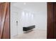 Bright living room with textured white wall, floating cabinets, and light tile flooring at 2600 Pisces Dr, Orlando, FL 32837