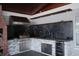 A well-equipped outdoor kitchen boasts stainless steel appliances, a built-in grill, and stylish stone accents at 2600 Pisces Dr, Orlando, FL 32837