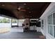 Spacious covered outdoor kitchen area with brick oven, grill, and island at 2600 Pisces Dr, Orlando, FL 32837