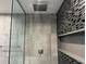 Modern shower featuring gray and mosaic tile and dual shower heads at 2600 Pisces Dr, Orlando, FL 32837