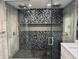 Beautiful glass shower with gray and mosaic tile and dual shower heads at 2600 Pisces Dr, Orlando, FL 32837