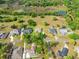 Overhead view showcases a home within a community, surrounded by lush greenery and various amenities at 26301 Sackamaxon Dr, Sorrento, FL 32776