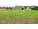 Expansive backyard featuring a lush lawn and a covered patio, perfect for outdoor entertaining at 26301 Sackamaxon Dr, Sorrento, FL 32776