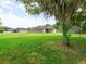 Expansive backyard with well-manicured lawn and view of the rear exterior of the house at 26301 Sackamaxon Dr, Sorrento, FL 32776