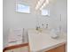 Bathroom vanity area with ample counter space, decorative mirror, and natural lighting at 26301 Sackamaxon Dr, Sorrento, FL 32776