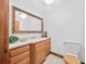 Bright bathroom with quartz countertop vanity, toilet, and oversized framed mirror at 26301 Sackamaxon Dr, Sorrento, FL 32776