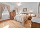 Bedroom with hardwood floors and natural lighting with patterned curtains at 26301 Sackamaxon Dr, Sorrento, FL 32776