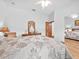 Well-lit bedroom with hardwood floors, white walls, ceiling fan, and a large mirrored closet at 26301 Sackamaxon Dr, Sorrento, FL 32776
