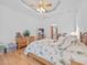 Comfortable bedroom features hardwood floors, a ceiling fan, and bright natural light at 26301 Sackamaxon Dr, Sorrento, FL 32776