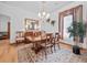 Elegant dining room with a chandelier, hardwood floors, and a large dining table at 26301 Sackamaxon Dr, Sorrento, FL 32776