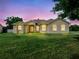 Charming one-story home with a lush green lawn and well-maintained landscaping at 26301 Sackamaxon Dr, Sorrento, FL 32776