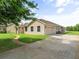 Home exterior featuring a spacious driveway leading to the attached two-car garage at 26301 Sackamaxon Dr, Sorrento, FL 32776