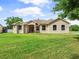 Charming single-story home with beautiful curb appeal, a well manicured lawn, and an arched entry at 26301 Sackamaxon Dr, Sorrento, FL 32776