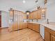 Well-equipped kitchen featuring stainless steel appliances, custom cabinetry and hardwood floors at 26301 Sackamaxon Dr, Sorrento, FL 32776