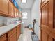 Functional laundry room with washer, dryer, sink, cabinets, and storage for household supplies at 26301 Sackamaxon Dr, Sorrento, FL 32776