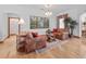 Bright living room showcasing hardwood floors, comfortable chairs, and a decorative chandelier at 26301 Sackamaxon Dr, Sorrento, FL 32776