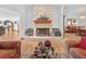 Cozy living room featuring a stone fireplace, hardwood floors, and comfortable seating at 26301 Sackamaxon Dr, Sorrento, FL 32776