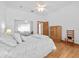 Bright main bedroom featuring hardwood floors and mirrored closet at 26301 Sackamaxon Dr, Sorrento, FL 32776