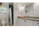 Bathroom features a shower with tile surround, vanity with granite countertop, and a new toilet at 26535 Deuce Ct, Leesburg, FL 34748
