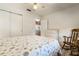 Bright bedroom featuring natural light, closet, ceiling fan, and a rocking chair at 26535 Deuce Ct, Leesburg, FL 34748