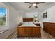 Bedroom with hard surface flooring, a large bed and ample windows for natural light at 26535 Deuce Ct, Leesburg, FL 34748