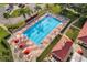 Aerial view of a large community pool surrounded by lounge chairs and well-maintained landscaping at 26535 Deuce Ct, Leesburg, FL 34748