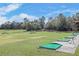 Well-kept community driving range with designated hitting areas and picturesque views at 26535 Deuce Ct, Leesburg, FL 34748