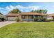 Charming single-story home with a well-maintained lawn, a two car garage, and appealing curb appeal at 26535 Deuce Ct, Leesburg, FL 34748