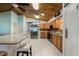 Bright kitchen with an island, stainless steel appliances, and a vaulted wood plank ceiling at 26535 Deuce Ct, Leesburg, FL 34748